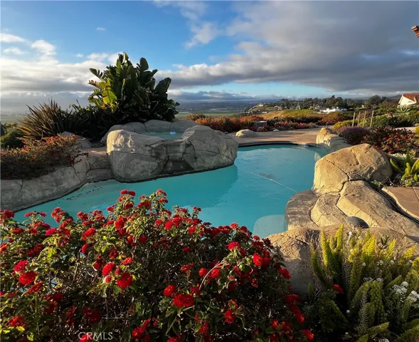 Lagoon style pool with jacuzzi and waterfall feature.