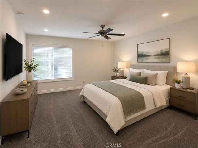 Primary bedroom with virtual furniture. Furniture and décor have been digitally added for illustrative purposes only and are not included with the property.