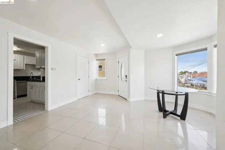 Open concept living space featuring neutral tile flooring throughout