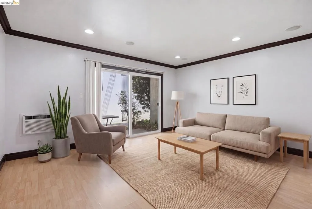 Light wood-finish flooring with dark trim molding