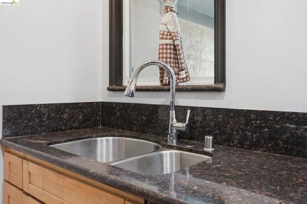 Double basin stainless steel sink with a high-arch chrome faucet
