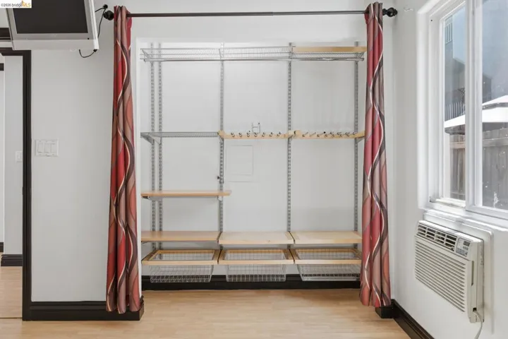 Integrated storage system featuring adjustable shelving, hanging rods, and wire baskets