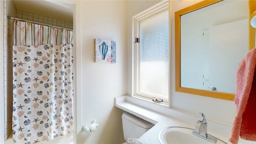 Private bath with tub and shower combination.