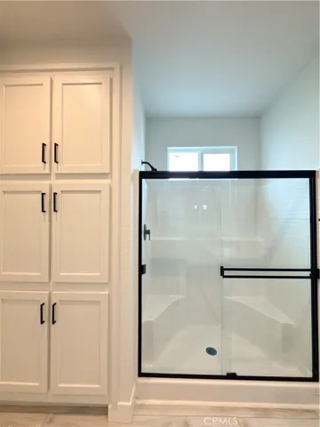 Primary bathroom with tub/shower and storage