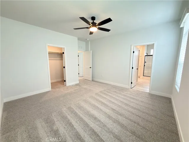 Primary bedroom with walk-in closet and en suite bathroom