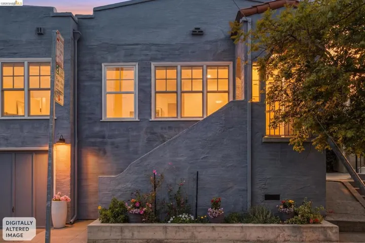 Stucco exterior featuring multiple gridded windows, a curved exterior staircase, and a concrete planter box