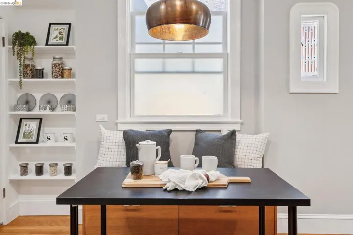Built-in banquette seating with integrated storage, featuring a black tabletop and wood-finish cabinetry