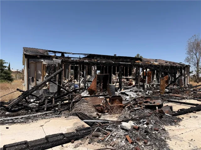 Wide view of fire destruction and backyard debris