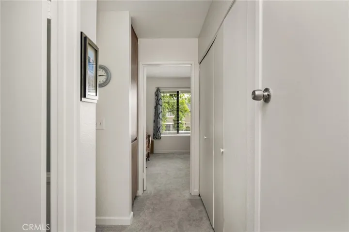 Hall between Bedrooms with Laundry (side-by-side) on the right.