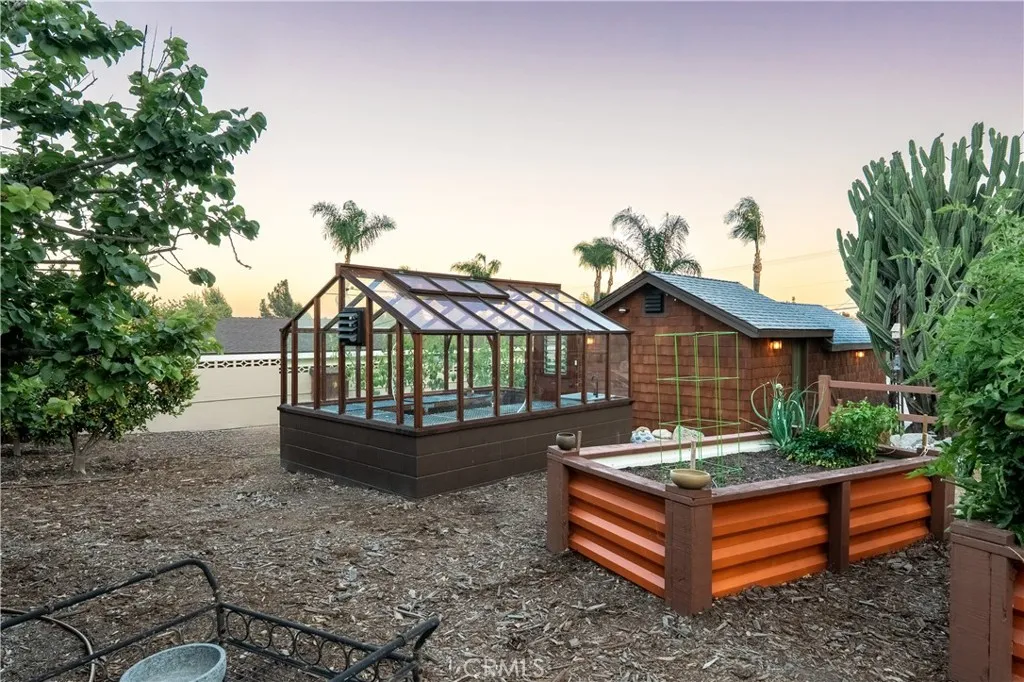 Garden beds and greenhouse in the evening Garden beds and greenhouse in the evening