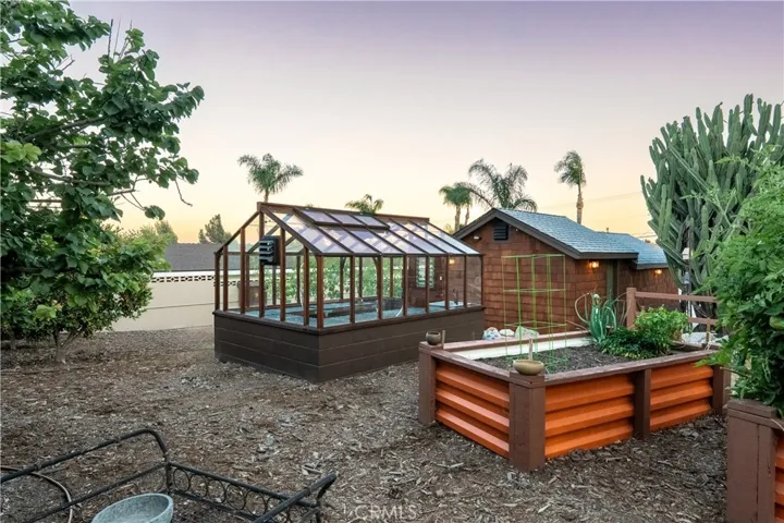 Garden beds and greenhouse in the evening