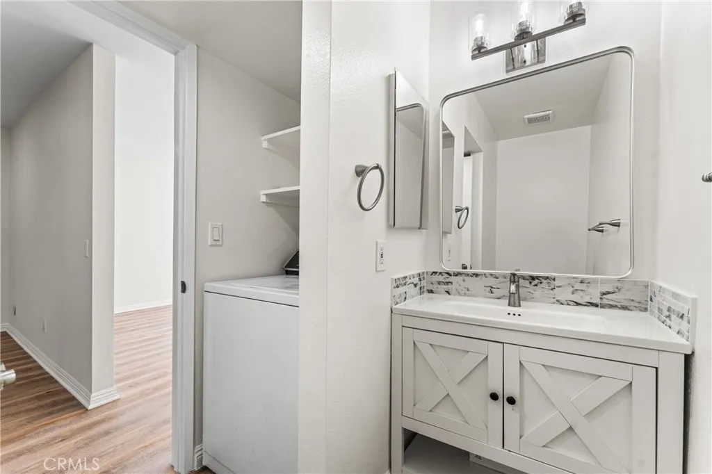 Downstairs powder bathroom with laundry.
