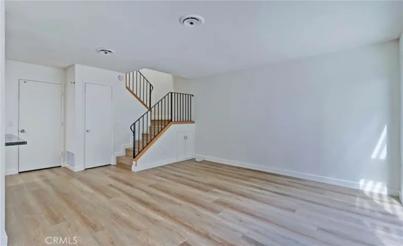 Light and bright living room is open to dining room, kitchen and patio.
Photo from prior to current tenant.