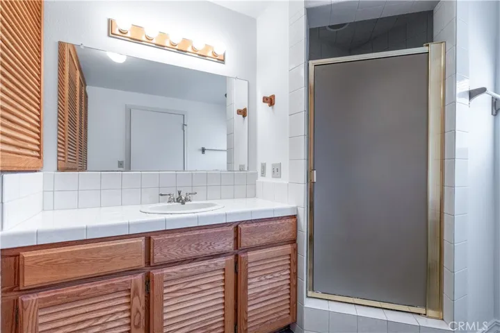 The bonus room on the lower level is complemented by a private, adjacent full bathroom, creating an ideal setup for a guest suite or a quiet home office.