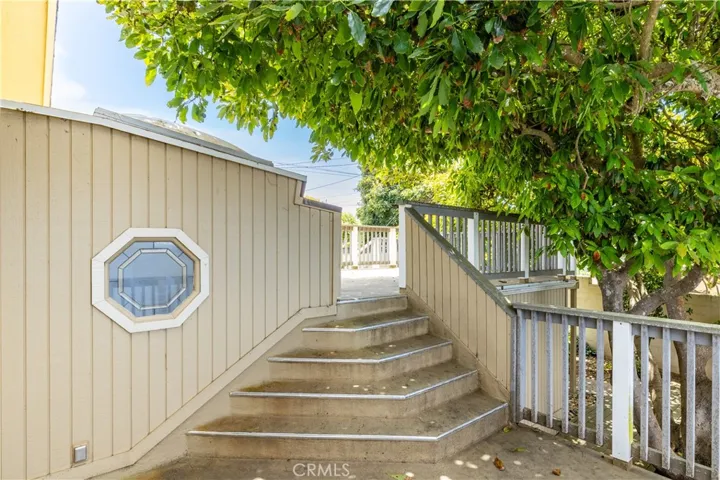 You'll find a delightful transition from the primary bedroom to the top deck, framed beautifully by a lush, mature avocado tree. It’s a wonderful, private spot that feels like your own personal oasis...complete with plenty of fresh avocados for all the guacamole you could ever want!