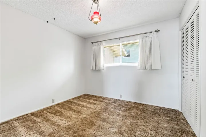 This flexible bedroom space is perfectly sized for a guest room or a home office