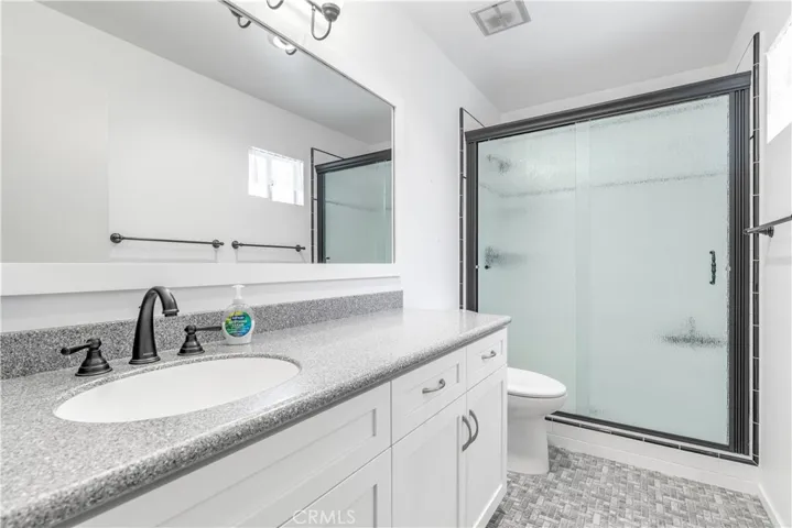 Enjoy the convenience of a dedicated primary en-suite, featuring a clean, updated shower design and ample space
