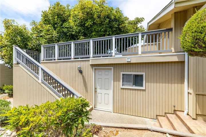 The home features a practical and inviting layout, where a dedicated exterior staircase provides seamless, private access to the upper deck and primary bedroom. Positioned alongside the bonus room addition, this design offers a nice, functional connection between the lower bonus addition space and the outdoor deck above.