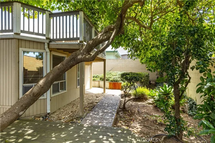 Step into your own private retreat, where a charming wooden deck flows right into a peaceful, lush garden space. It’s a wonderful spot to unwind, featuring a lovely mature tree that reaches gracefully over the deck, creating a natural, dappled shade that feels perfectly cozy. With its relaxed atmosphere and leafy greenery, this backyard is just waiting to become your favorite place to enjoy a quiet morning coffee or a relaxing afternoon outdoors.