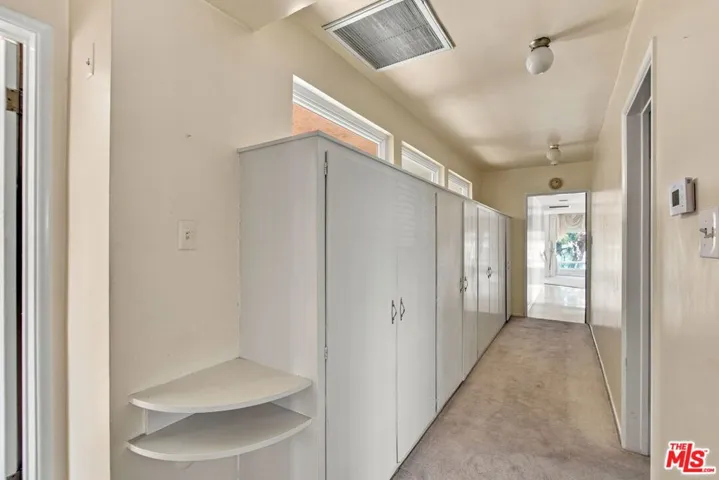 East wing of home w/wall of cl