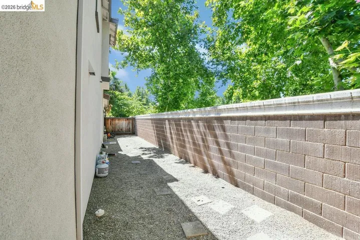 Gated dog run or could be used as possible RV storage. Approximately 10 ft wide.