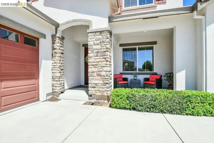 Exterior featuring stone column accents and an arched entryway