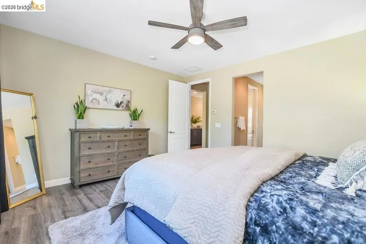LVP flooring, and a contemporary ceiling fan with integrated lighting