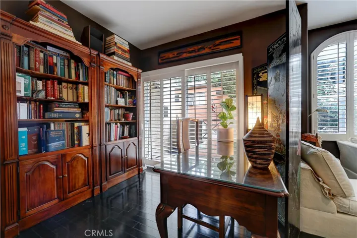 Living room w/built in library, plantation shutters, gorgeous floors