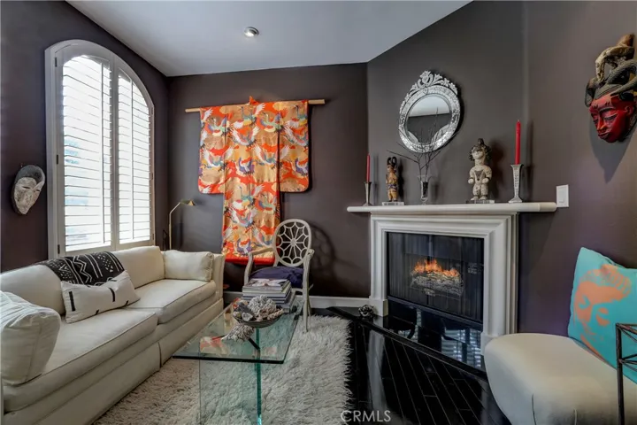 Living room w/fireplace, plantation shutters, gorgeous floors
