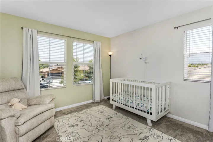 Bedroom upstairs with carpet, many windows for natural lighting