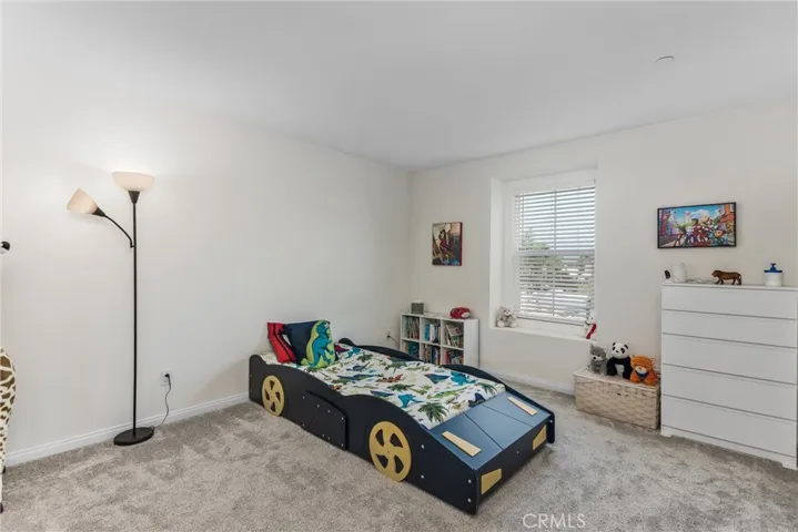 One of the upstairs spacious bedrooms with carpet w/ mirrored closets