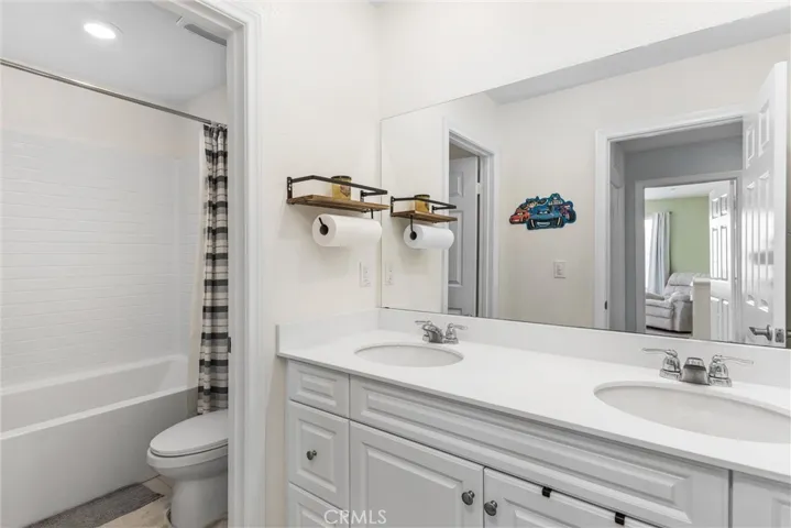 Upstairs hall bath has a tub/shower combo and dual vanity