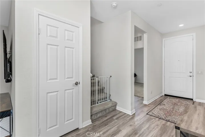 The entryway shows the location of the downstairs bedroom and the stairs leading to the 2nd floor.