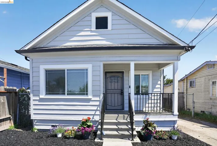 Light gray siding exterior with white trim and a black roof