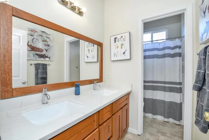 Dual vanity with white undermount sinks set in a light-colored countertop