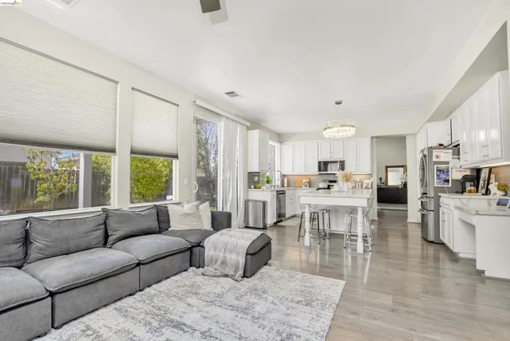 Open-concept living area with wood-finish flooring