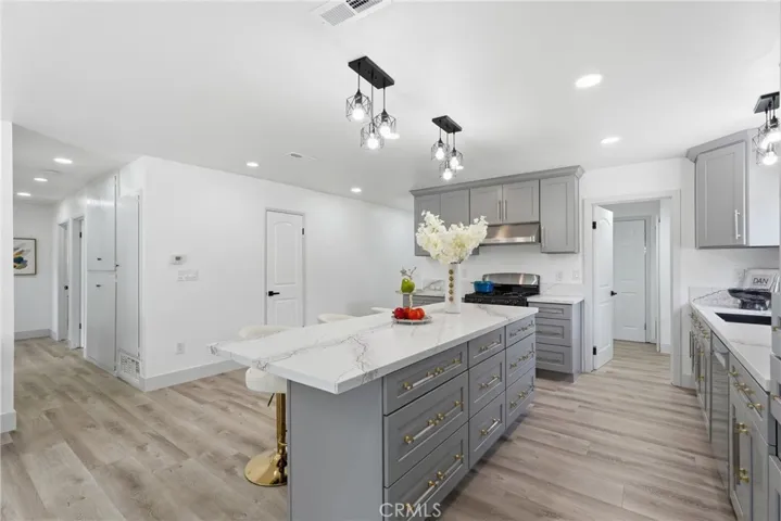 Remodeled Kitchen with Lots of Cabinetries and Quartz Counter Top