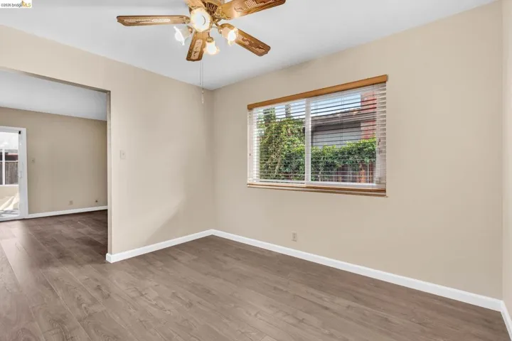 Neutral-toned walls complement the wood-finish flooring