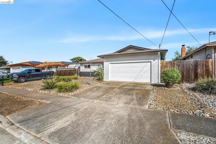 Single-story stucco exterior with an attached two-car garage