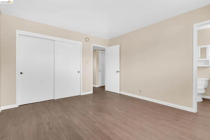Expansive room featuring wood-finish flooring and neutral-toned walls