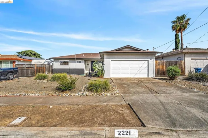 Single-story residence featuring a concrete driveway and an attached two-car garage