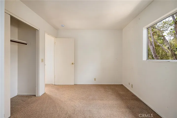 2nd bedroom is at end of hallway and faces toward back part of the home.
