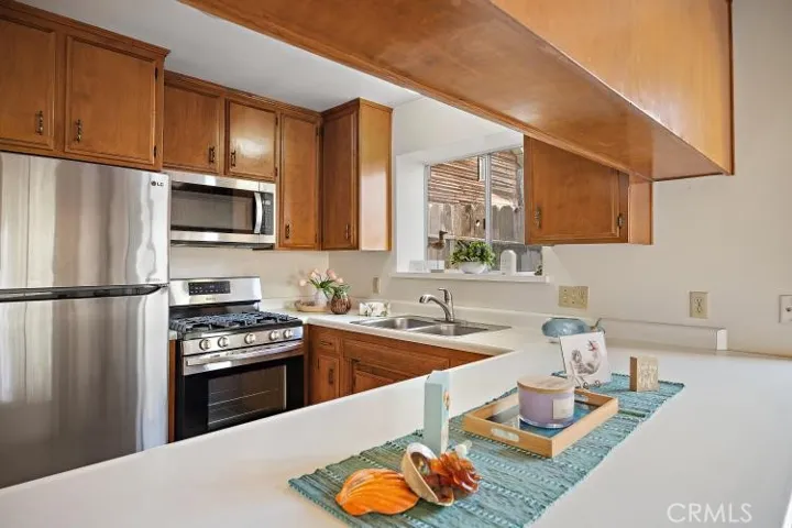 Full kitchen has plenty of cupboards and a breakfast bar.