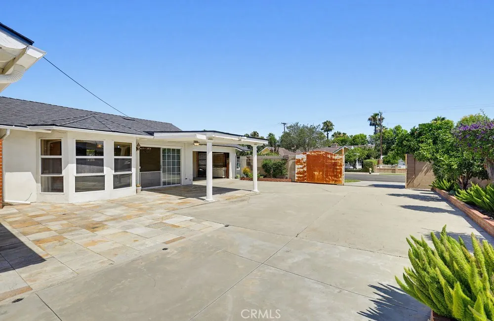 Backyard facing driveway entry
