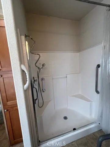 Primary Bath Walk in Shower with Bench Seating and Grab Bars