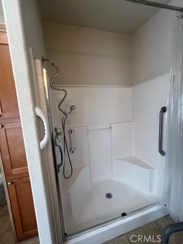 Primary Bath Walk in Shower with Bench Seating and Grab Bars
