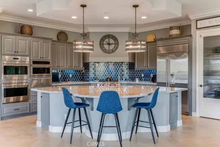 Double oven, 6 burner gas range, wine fridge, built-in refrigerator and large island