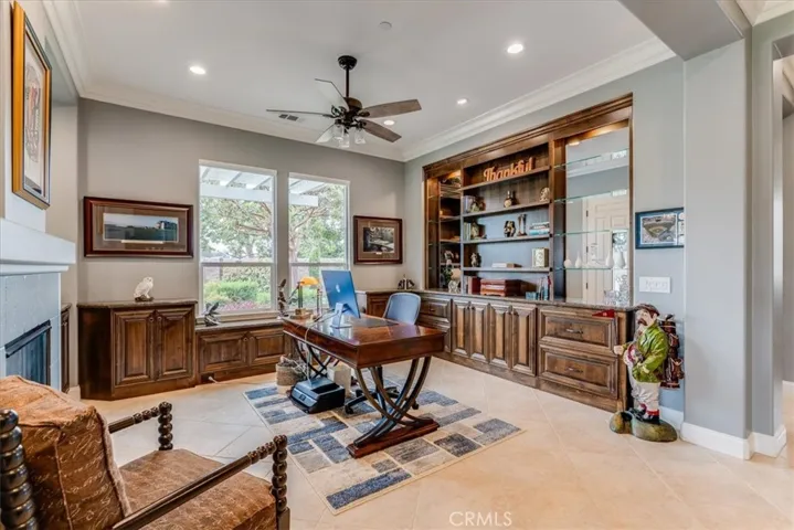 Den/Office with fireplace and custom cabinetry.