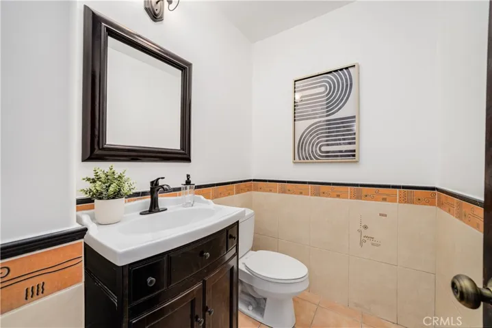 Half bathroom in hallway leading to bedrooms