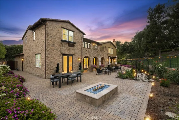 Huge 13,039 square foot lot with plush landscape, hardscape, pavers, lighting, built-in firepit